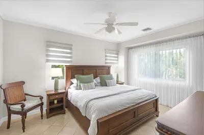 a bedroom with a bed and a chair and a window at Del Mar 5F 3 bedr 2 bath in Herradura