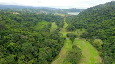 an overhead view of a golf course in a forest at Del Mar 5F 3 bedr 2 bath in Herradura