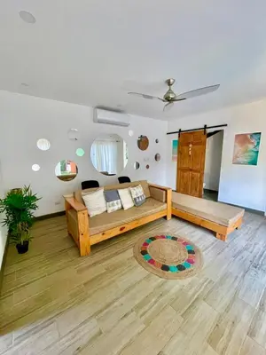 a large living room with a bed and a rug at Jaco Roca Bruja in Jacó