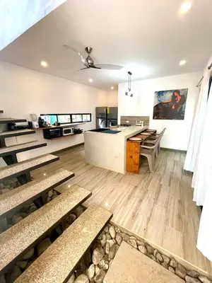 a cafeteria with benches and a counter in a room at Jaco Roca Bruja in Jacó