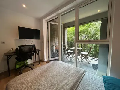 a room with a bed and a sliding glass door at Cocogarden in Coco
