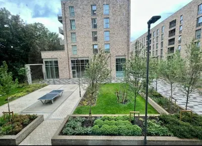 a park in front of a building with a bench at Cocogarden in Coco