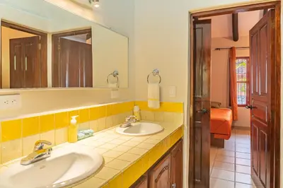 a bathroom with two sinks and a mirror at Casa Nubes - Ocean View in Carrillo