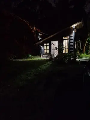 a house lit up at night in the dark at Pipe's Cabin in San Pablo