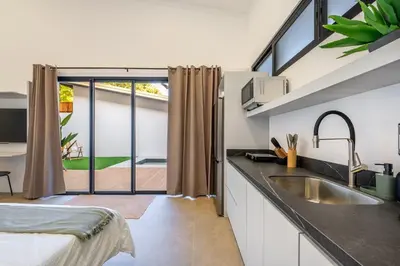 a kitchen with a sink and a large window at Pinilla Living Studio 2 in Santa Cruz