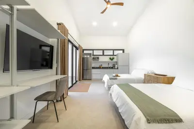 a bedroom with two beds and a flat screen tv at Pinilla Living Studio 2 in Santa Cruz