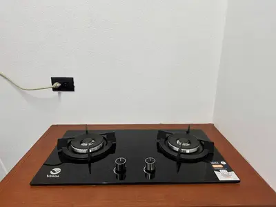 a black stove top in a corner of a room at Cozy Studio with private tropical forest in Tanque
