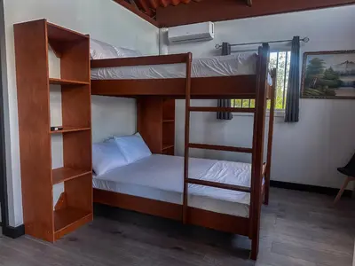 a couple of bunk beds in a room at Cozy Studio with private tropical forest in Tanque