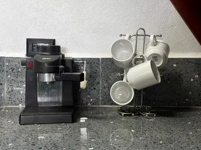 a kitchen with two cups and a coffee maker at Cozy Studio with private tropical forest in Tanque
