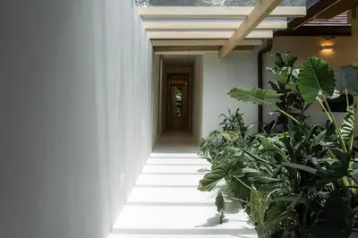 a hallway with plants in front of a building at GoldCoast Villa Santa Teresa in Santa Teresa Beach