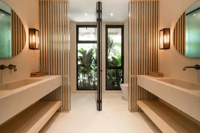 a bathroom with two sinks and a toilet at GoldCoast Villa Santa Teresa in Santa Teresa Beach