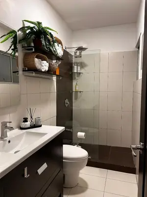 a bathroom with a toilet and a sink at Secure Retreat Near SJO and 27, Ideal for Families in Nuestro Amo