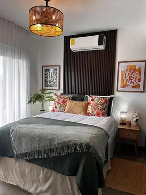 a bedroom with a large bed and a fan at Secure Retreat Near SJO and 27, Ideal for Families in Nuestro Amo