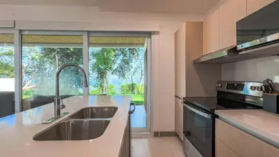 a kitchen with a sink and a large window at New 4BDR Ocean Mountain View Villa - Mar a Mar in Punta Leona