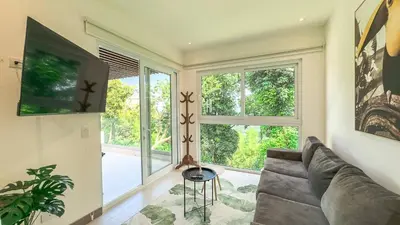 a living room with a couch and a large window at New 4BDR Ocean Mountain View Villa - Mar a Mar in Punta Leona