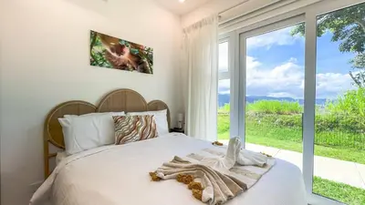 a bedroom with a bed and a large window at New 4BDR Ocean Mountain View Villa - Mar a Mar in Punta Leona
