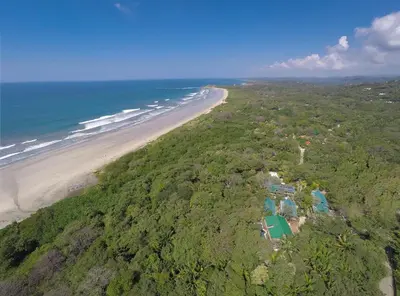 an aerial view of a beach and the ocean at Olas Verdes Hotel in Nosara