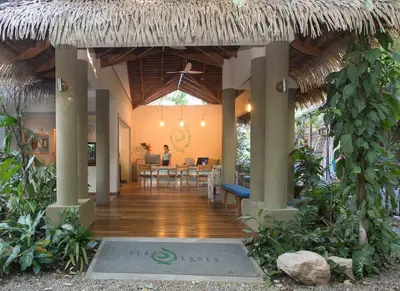 a lobby of a resort with a dining area at Olas Verdes Hotel in Nosara