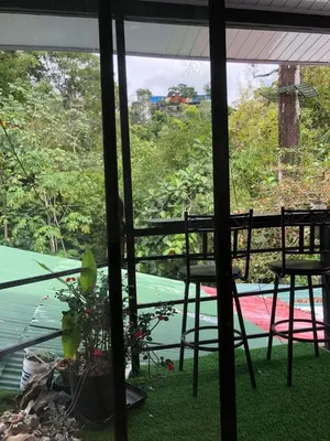 a view of a patio with a table and chairs at Casa Jenny in Quepos