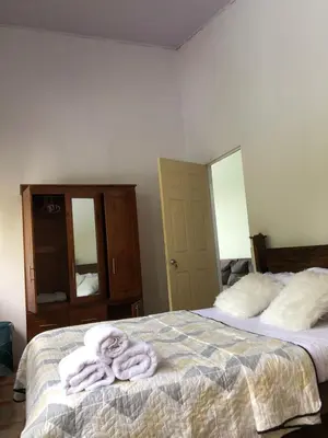 a bedroom with a bed with towels on it at Casa Jenny in Quepos