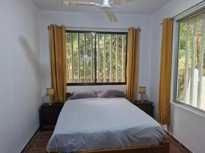 a bedroom with a bed and a large window at El Diamante - Playa Hermosa in Playa Hermosa