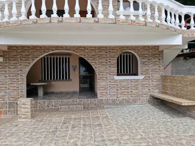 a building with a brick wall and a staircase at El Diamante - Playa Hermosa in Playa Hermosa