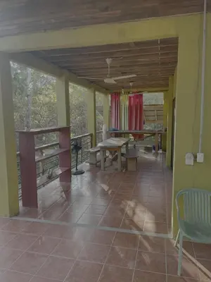 a porch of a house with a table and chairs at House on the Hill in Montezuma
