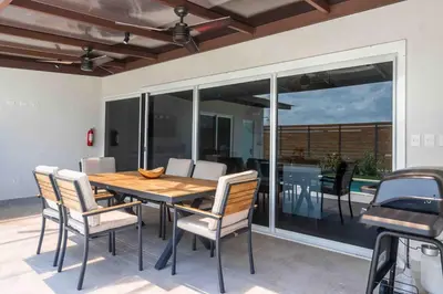 a dining room with a wooden table and chairs at Triskele Retreat - Combo Ocean and Earth in Esterillos