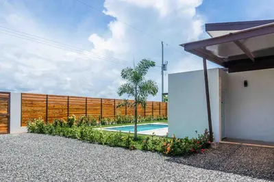 a swimming pool in the backyard of a house at Triskele Retreat - Combo Ocean and Earth in Esterillos