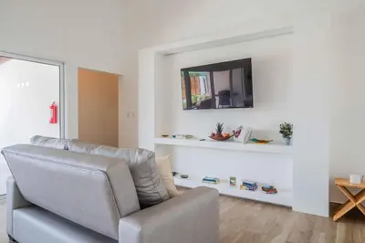 a living room with a couch and a mirror at Triskele Retreat - Combo Ocean and Earth in Esterillos