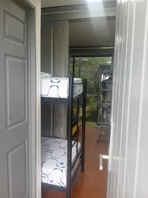 a room with two bunk beds and a door at Pupa House Hotel in Tamarindo