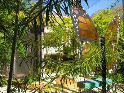 a butterfly ornament hanging from a tree at Pupa House Hotel in Tamarindo