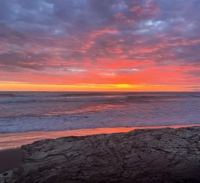 a sunset on a beach with the ocean at Beach Apartment with Pool and Lake - Playa Hermosa in Playa Hermosa