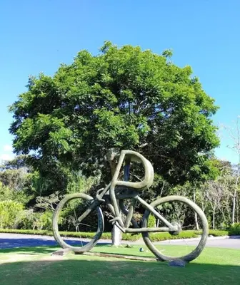 a statue of a bicycle in front of a tree at Beach Apartment with Pool and Lake - Playa Hermosa in Playa Hermosa