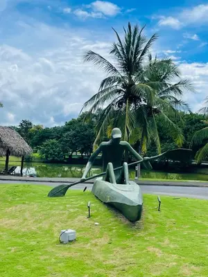 a statue of a man sitting on a boat in a field at Beach Apartment with Pool and Lake - Playa Hermosa in Playa Hermosa
