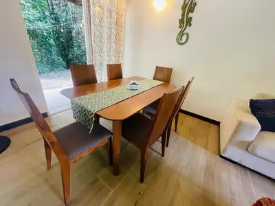 a dining room table and chairs in a room at Beach Apartment with Pool and Lake - Playa Hermosa in Playa Hermosa