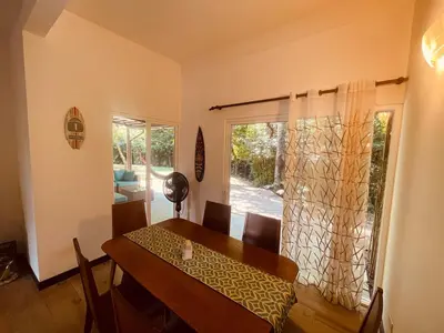 a dining room with a table and a window at Beach Apartment with Pool and Lake - Playa Hermosa in Playa Hermosa
