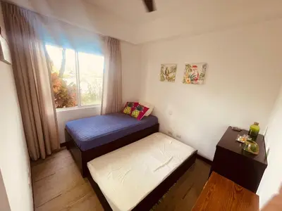 a small room with a bed and a window at Beach Apartment with Pool and Lake - Playa Hermosa in Playa Hermosa