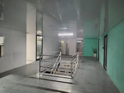 an empty hallway with a staircase in a building at Hostel La Bambú in Quepos