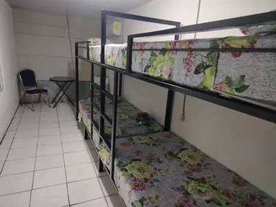 a group of bunk beds in a room at Hostel La Bambú in Quepos