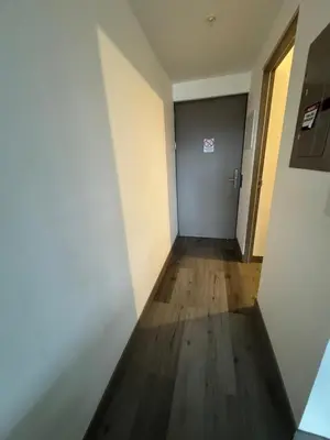 a hallway of an office with a door and wooden floors at Sky Escalante Apartment in San José