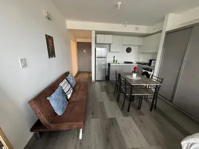 a living room and kitchen with a couch and a table at Sky Escalante Apartment in San José