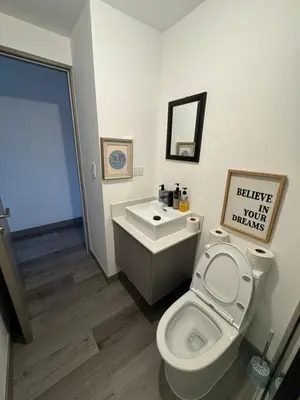 a bathroom with a toilet and a sink at Sky Escalante Apartment in San José