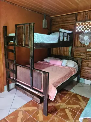 a bedroom with two bunk beds in a room at Tío Felix Eco Lodge in Fortuna