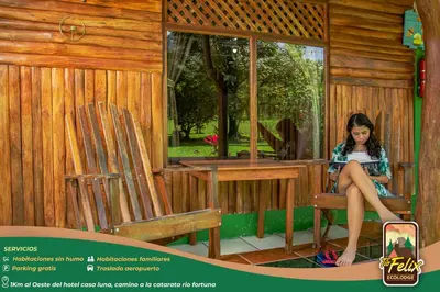 a woman sitting in a chair in a house at Tío Felix Eco Lodge in Fortuna