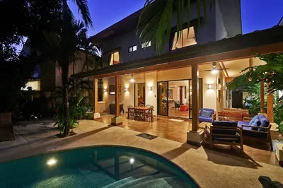 a house with a swimming pool in front of a house at Villa Louise 4BR Modern Villa - Few Steps from the Beach in Santa Teresa Beach