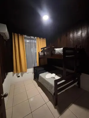 a bedroom with two bunk beds in a room at Cabana los Tutos, relajate y disfruta in Fortuna