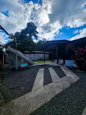 a walkway in front of a building at Cabana los Tutos, relajate y disfruta in Fortuna