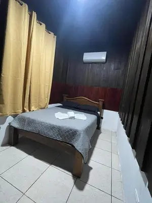 a bedroom with a bed with two towels on it at Cabana los Tutos, relajate y disfruta in Fortuna
