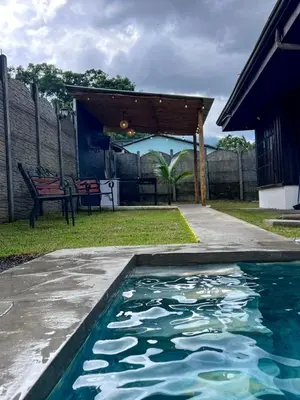 a swimming pool in the backyard of a house at Cabana los Tutos, relajate y disfruta in Fortuna